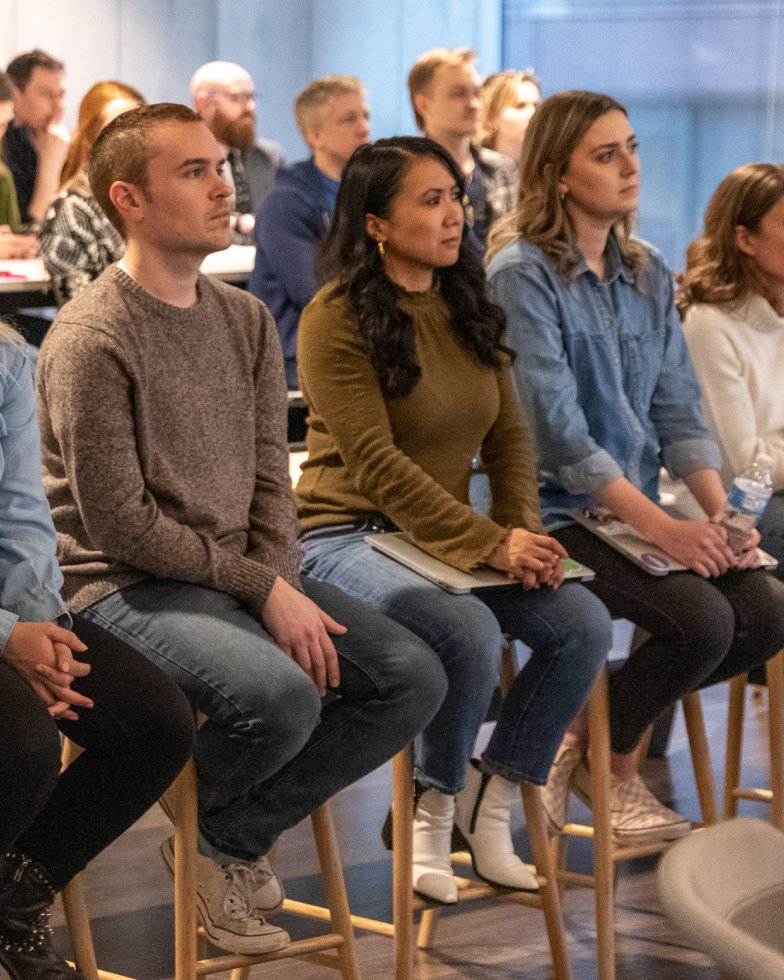 Sprout employees listening intently during a DEI Guild meeting presentation.