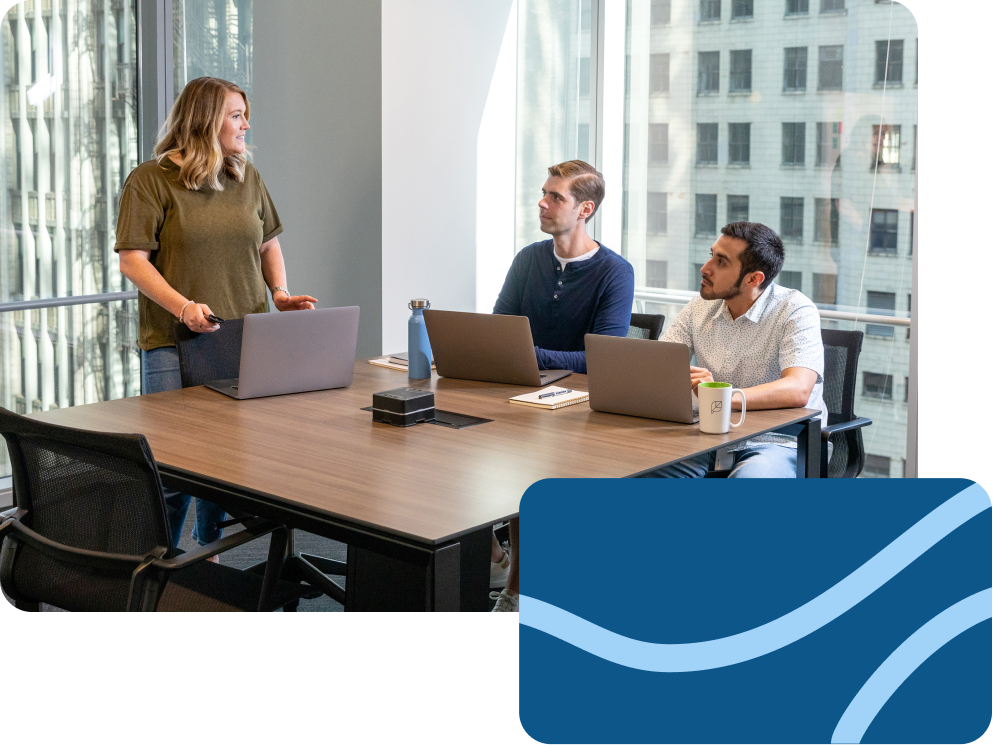 Three team members deep in discussion during a meeting.