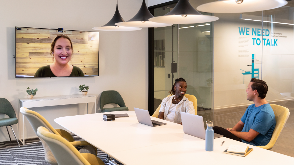  A hybrid team meeting with both in-office and remote team members.